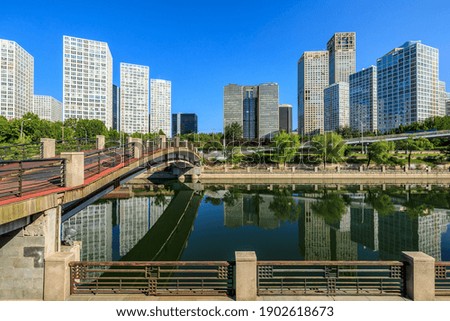 Modern city commercial buildings and water reflection in Beijing,China.