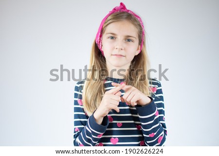 Little girl over white background doing stop sing with fingers of the hand. Warning expression with negative and serious gesture on the face.