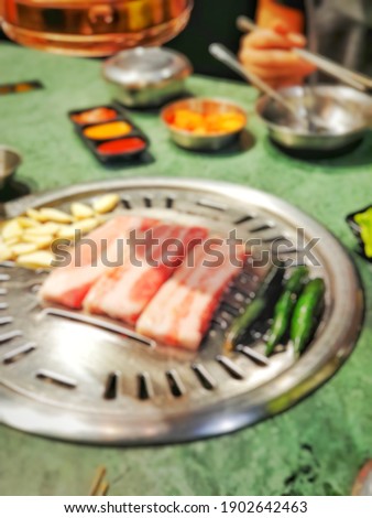 Blur picture background of grilled pork belly on the stove at Korean restaurant in Bangkok,  Thailand,  Asia. 