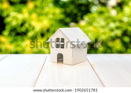 The symbol of the house on a natural green background
