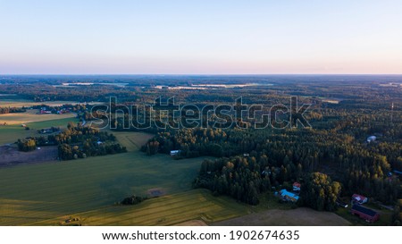 Sunset over the forest of the countryside town of Skinnarby, Finland.