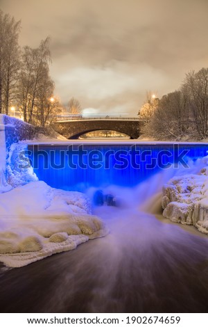 Rapids light up blue in the winter at Vanhankaupunginkoski, Helsinki, Finland.
