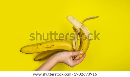Ripe, tropical banana on a yellow background. Natural banana peel. Fruits.