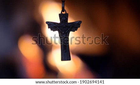Crucifix Silhouette on Fire Flames Defocused Dark Background Slow Motion Royalty-Free Stock Photo #1902694141