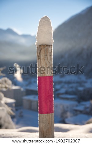 post at footpah on winter hiking trail after snowfall at Davos Switzerland. High quality photo