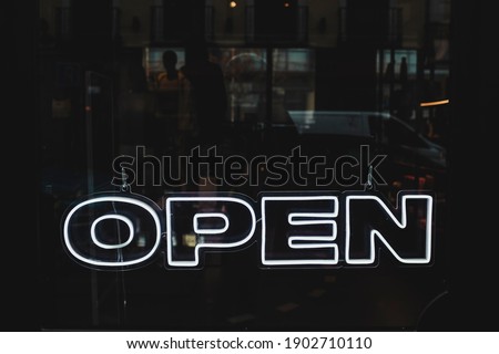The word Open designed with white neon lights. Safety and trust concept.