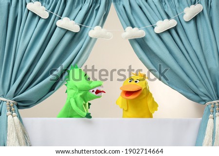 Creative puppet show on white stage indoors Royalty-Free Stock Photo #1902714664