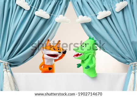 Creative puppet show on white stage indoors Royalty-Free Stock Photo #1902714670