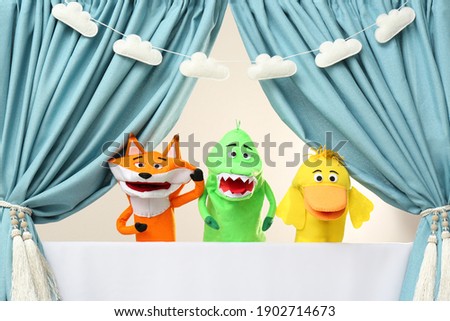 Creative puppet show on white stage indoors Royalty-Free Stock Photo #1902714673