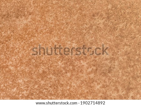 Particleboard material, pressed wood texture, brown or orange chipboard background.