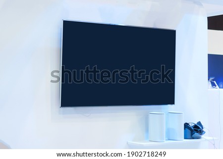 Blank lcd smart TV presentation at event convention exhibit trade show and booth in conference hall, white Mock up blank advertising on blue background