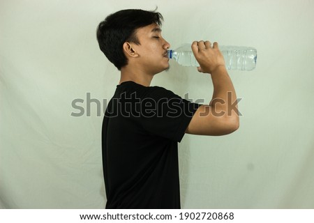 man drinking mineral water side view isolated on white background