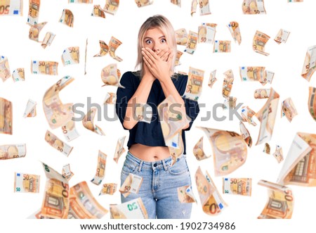 Young beautiful blonde woman wearing casual t-shirt shocked covering mouth with hands for mistake. secret concept.