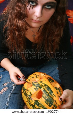 Adorned girl to Halloween c by pumpkin in the hands
