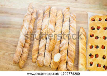 Delicious freshly baked bread on wooden background with focaccia, top view