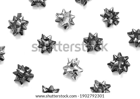 Pattern of silver bows on white background