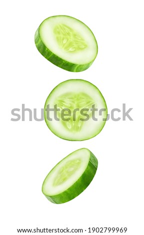 Cucumber slices falling, hanging, flying, soaring isolated on a white background with clipping path. Full depth of field. Royalty-Free Stock Photo #1902799969