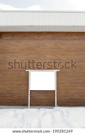 Empty billboard on brick wall