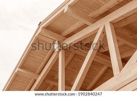 Wooden roof structure. Glued laminated timber roof. Rafters made of wood. Royalty-Free Stock Photo #1902840247