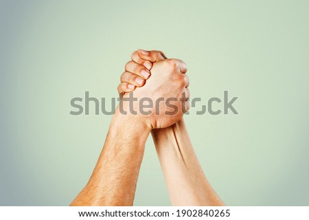 Rivalry concept. Two men arm wrestling. Hand, rivalry, vs, challenge, strength comparison. Two muscular hands
