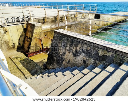 prirs with handrails by the sea in sunny weather Royalty-Free Stock Photo #1902842623