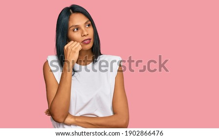 Young african american woman wearing casual clothes looking stressed and nervous with hands on mouth biting nails. anxiety problem. 