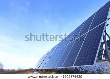 Solar panels Photovoltaic cells on a background of sunrise. Solar panels, the beginning of winter. Alternative ecological energy. Royalty-Free Stock Photo #1902876430