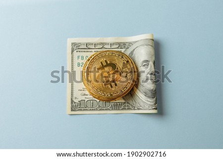 Bitcoin on dollar on a blue background. High quality photo