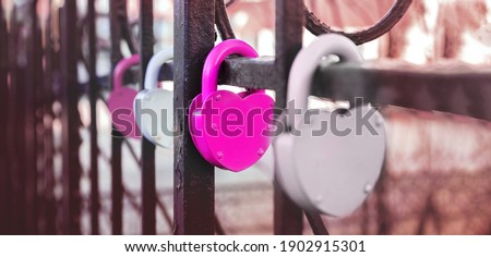 Closed padlock and heart shape as a symbol of eternal love. Concept for valentine's day. Blurred image, selective focus.