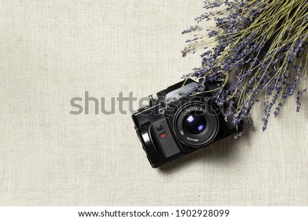 Top view of vintage camera and lavender on linen background. Whit space for your text. Travel concept in France 