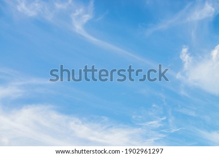 Scenic nature landscape with beautiful cirrus clouds in blue sky. Colorful cloudscape with spindrift clouds in blue sky. Nature background of sky with cirrostratus clouds. Natural cloudy sky backdrop. Royalty-Free Stock Photo #1902961297