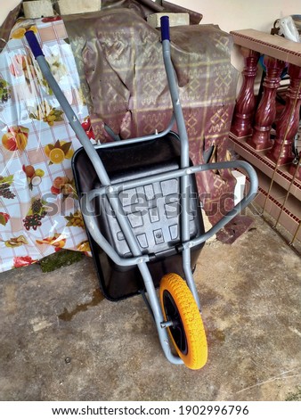 An image of a wheelbarrow. Wheelbarrow is used for carrying things ,mostly used for construction.