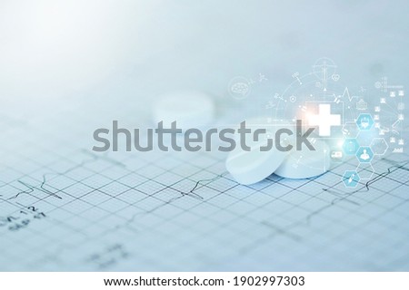 Medicine and heath concept. Pills and icon network medical heath care on doctor heart rate report background. 