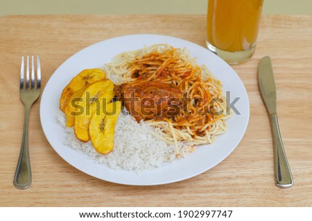 White rice, spaghetti with chicken sauce and slices of ripe plantain, a popular dish from the Panamanian daily life cuisine