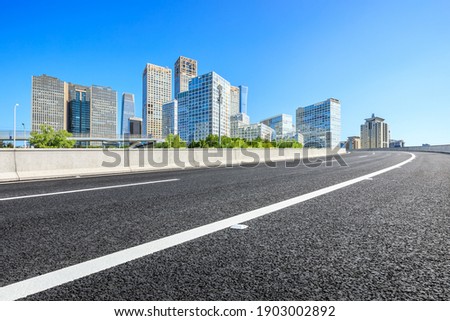 Asphalt road and modern city commercial buildings in Beijing,China.