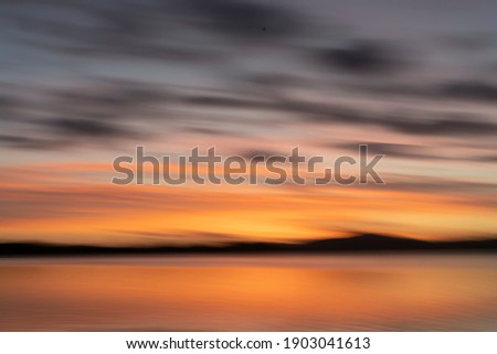 Abstract backgound Tauranga golden hour morning light over Waimapu Estuary bay motion blur abstract.