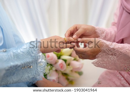 Picture  woman with wedding ring.Young married couple holding hands, ceremony wedding day. Newly wed couple's hands with wedding rings.