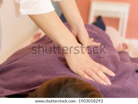 The hand of the person doing the massage.