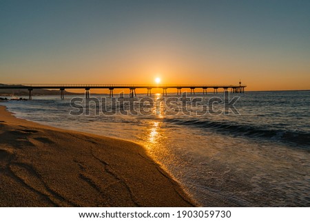 Pont del Petroli bridge in Badalona, Spain Sunrise over the sea Royalty-Free Stock Photo #1903059730