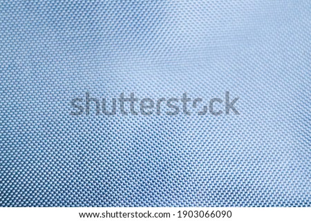 The blue texture of cloth in abstract close up for background. close up texture blue fabric of the suit, photoshoot by the depth of field for the object.