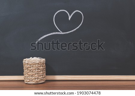A kettle and a heart shape on the blackboard