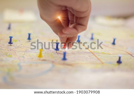 Soft focus hand holding paper pin on blur perspective road map,copy space.filter color effect. Royalty-Free Stock Photo #1903079908