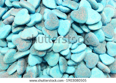 candy heart for Valentine's day. Candy A lot of sweets. Colorful texture using a background. Background rendering. Bright multiple jelly candies in powdered sugar. Confectionery wallpaper concept