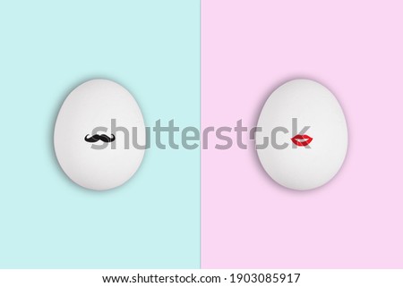 White easter egg with black gentleman mustache on blue background and egg with lady red lips on pink background