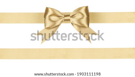Gold satin ribbon fabric bow isolated on white background. Royalty-Free Stock Photo #1903111198