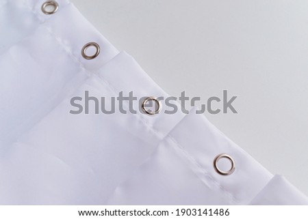 White shower curtain hooks, close up view. Top view. Royalty-Free Stock Photo #1903141486