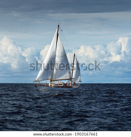 Old expensive vintage two-masted sailboat (yawl) close-up, sailing in an open sea. Coast of Maine, US. Sport, cruise, tourism, recreation, leisure activity, transportation, nautical vessel Royalty-Free Stock Photo #1903167661