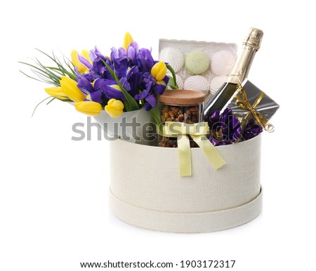 Basket with gifts, bouquet and champagne on white background Royalty-Free Stock Photo #1903172317