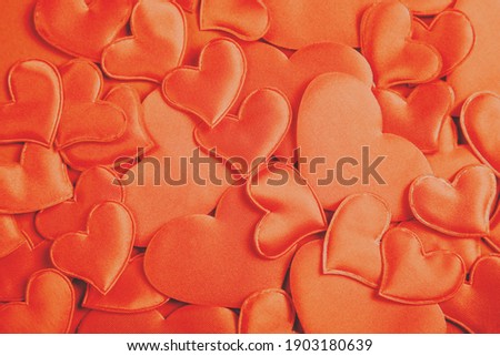 Orange hearts on color background. Monochrome. Great design for Valentine's Day