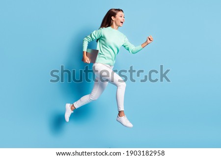 Profile photo of shiny cute girl wear casual outfit white pants hurrying running holding e-book gadget isolated blue color background